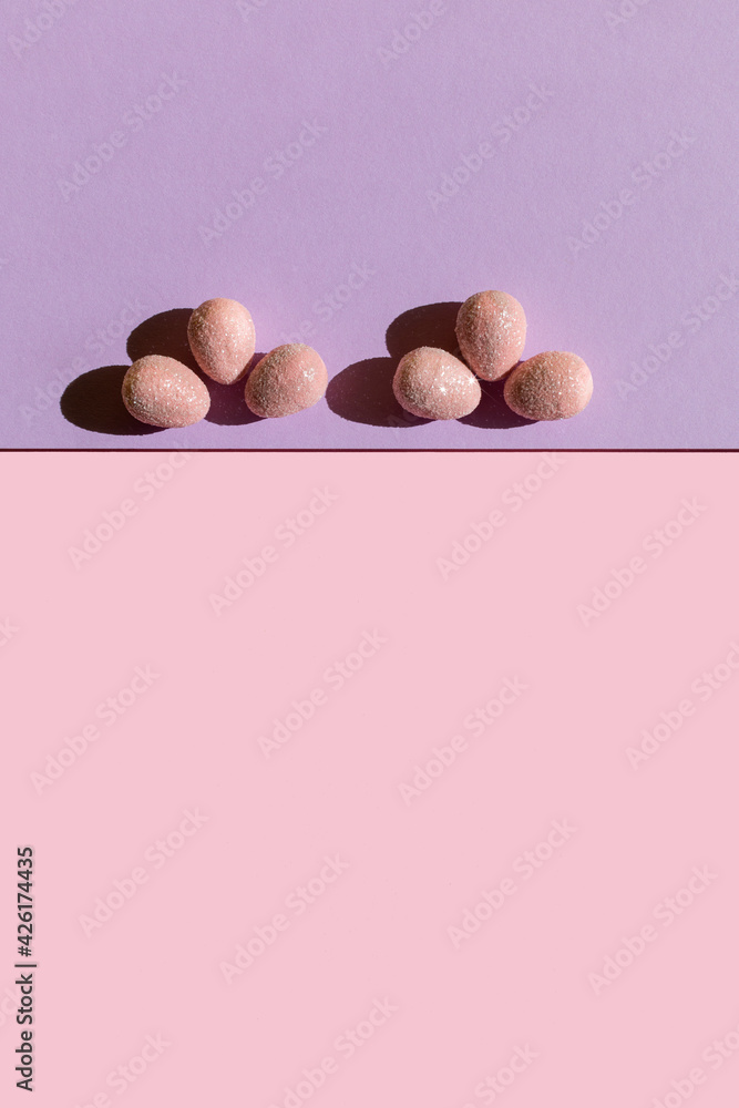 Abstract Easter layout with eggs and trend summer shadows on two tone pastel pink and purple background. Vertical photo. Copy space. Flat lay. Abstract Easter layout with eggs and trend summer shadows on two tone pastel pink and purple background. Vertical photo. Copy space. Flat lay.