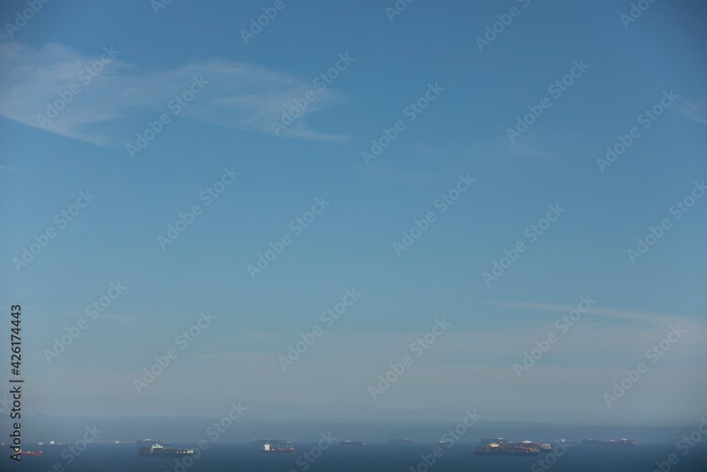 Cargo ships wait to be unloaded at a port. Cargo ships wait to be unloaded at a port.
