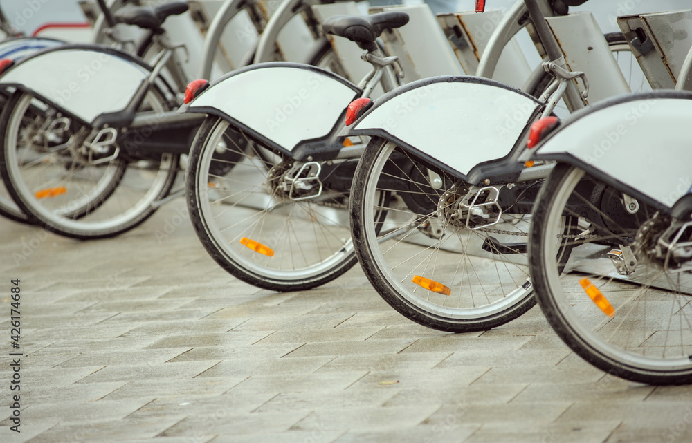 row of rental bikes on a street