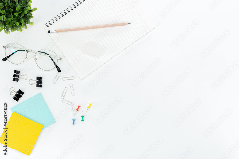 Top view of a desk with a coffee cup , mouse, notebooks, post-it, , glasses and element isolated on white background Top view of a desk with a coffee cup , mouse, notebooks, post-it, , glasses and element isolated on white background