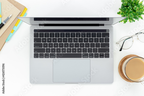 Top view work space with laptop , coffee cup, and plant isolated on white background with copy space