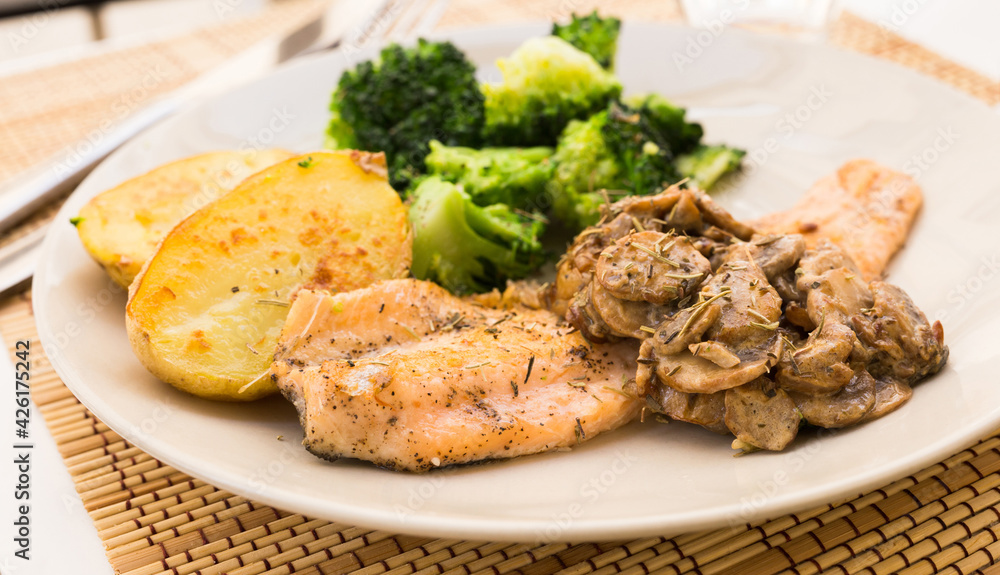 fried river trout fillet with a complex side dish of broccoli, baked potatoes and mushroom sauce fried river trout fillet with a complex side dish of broccoli, baked potatoes and mushroom sauce