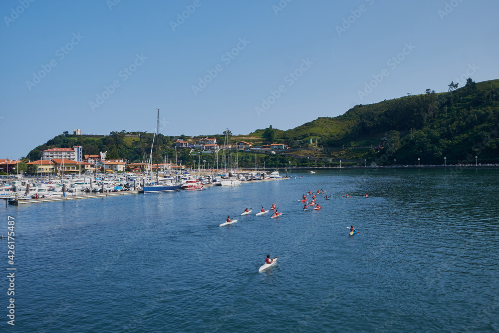 View of the Ribadesella estuary (Ribeseya) with athletes practicing canoeing. Town in eastern Asturias.