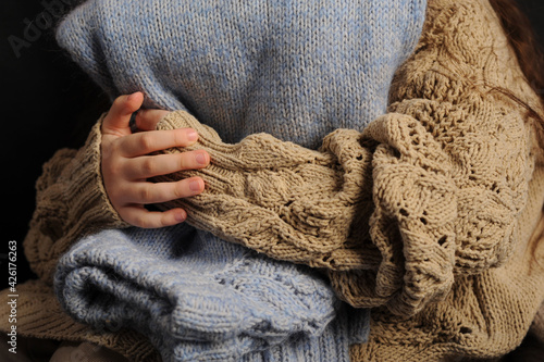girl holding a warm knitted sweater