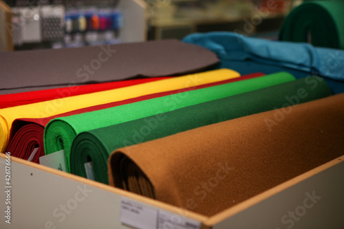 Stack of green  brown  yellow  red fabric rolls. Handwork or craft purpose.  