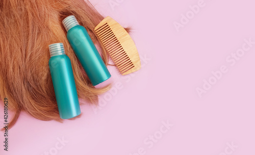  shampoo  wooden comb on a colored background