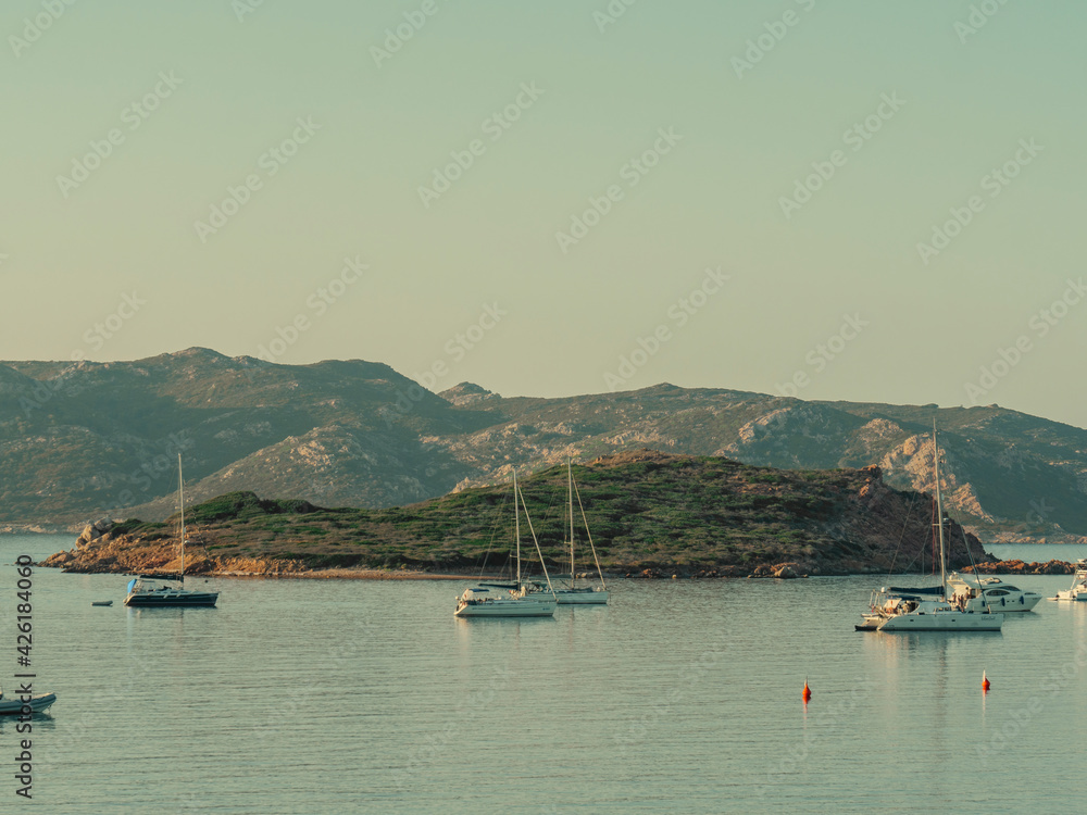 beach Capo Coda Cavallo with yachts moored in the sea