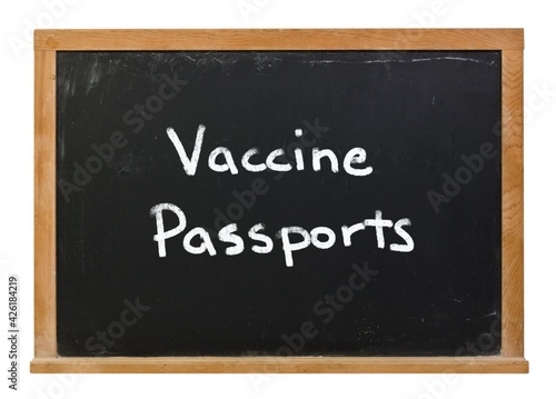 Vaccine Passports written in white chalk on a black chalkboard isolated on white