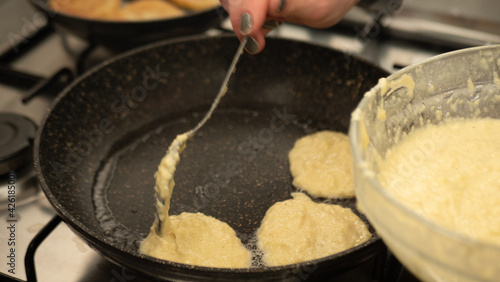 cook frying breadcrumbs on a frying pan, close up photo