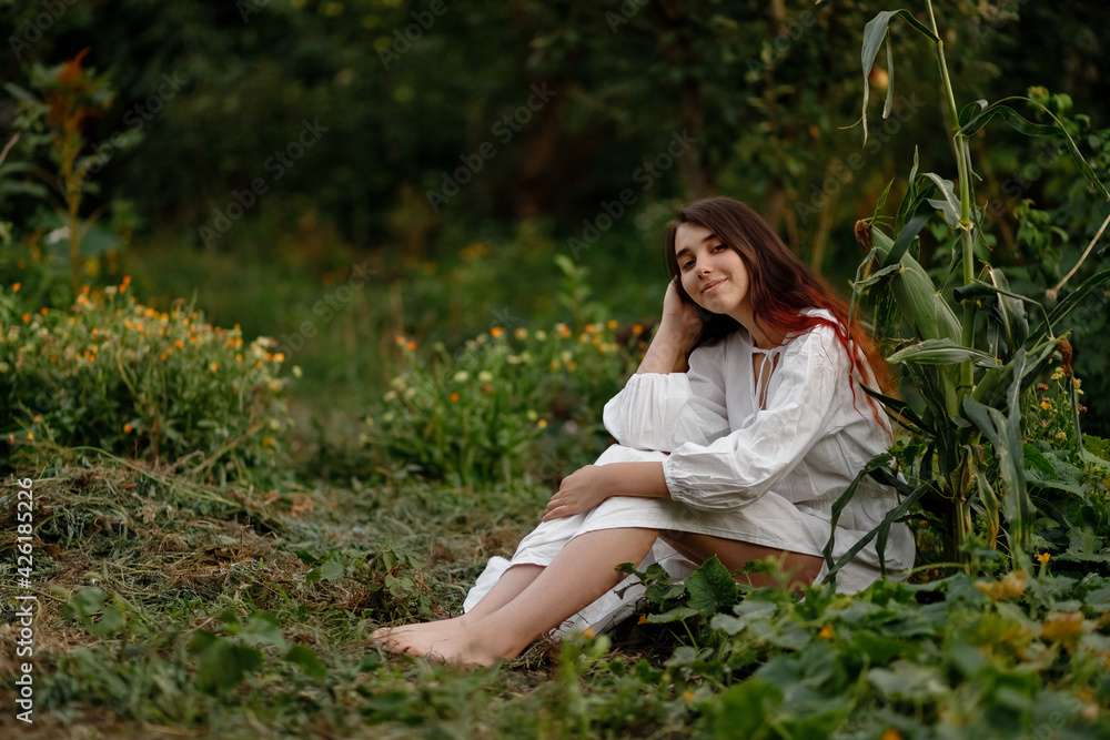 beautiful redhead girl in a white dress outdoors on a sunny day beautiful redhead girl in a white dress outdoors on a sunny day