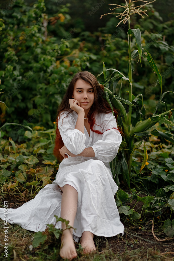 beautiful redhead girl in a white dress outdoors on a sunny day beautiful redhead girl in a white dress outdoors on a sunny day