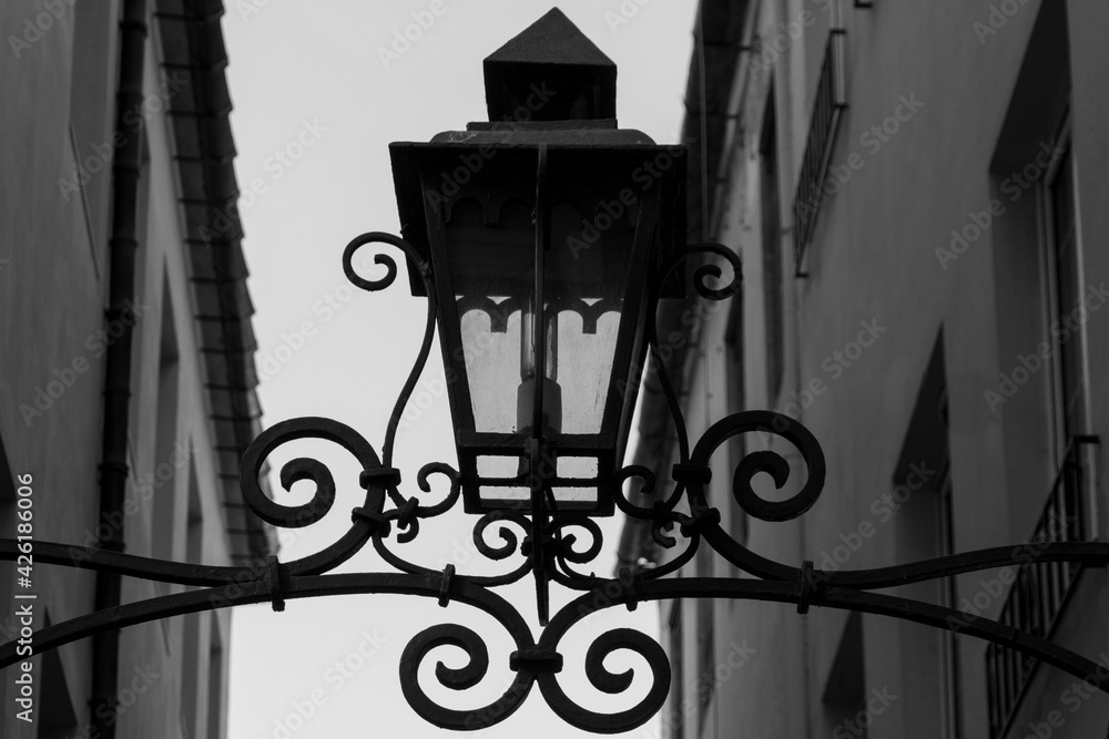 Old Lamp on a Metal Frame in a Street Old Lamp on a Metal Frame in a Street