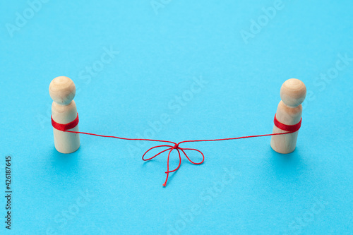 Love in the distance. Two figures of people connected by a thread, best friends forever.