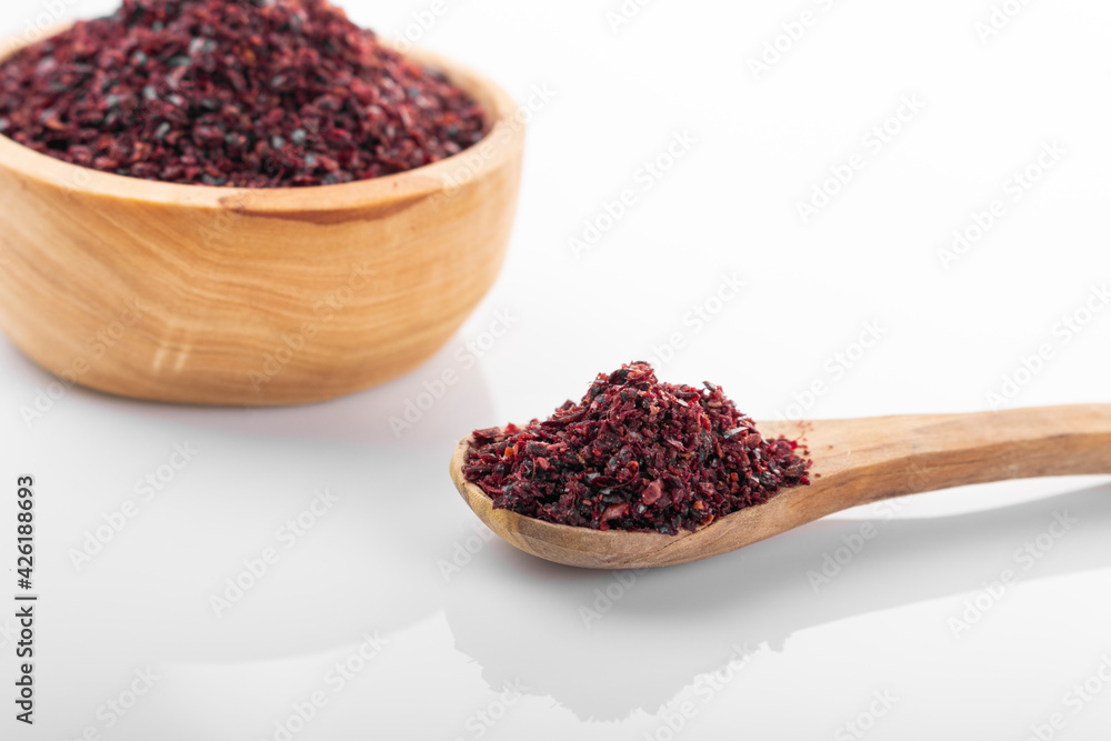 Sumac. Sumac spice in wooden bowl, on white background. Sumac, sumac