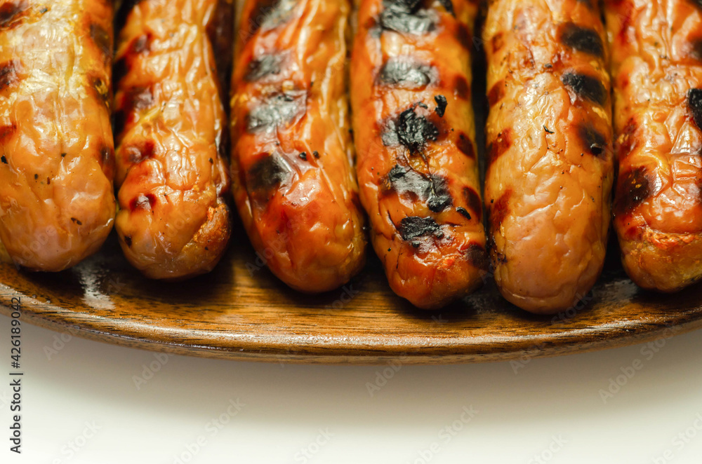 Grilled classic British sausage made from prime cuts of pork on the wooden plate