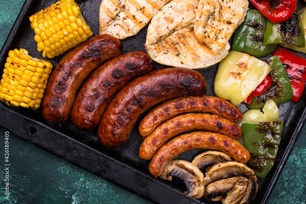 Grilled sausages, meat, and vegetables. Grilled sausages, meat, and vegetables.