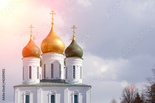 Russian Christian Orthodox church with domes and a cross against the sky. Russian Orthodoxy and Christian Faith concept.
