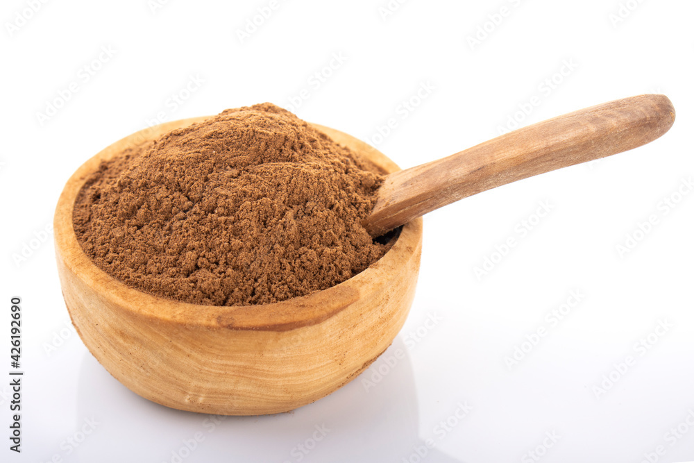 Cinnamon, cinnamon powder. Cinnamon powder in wooden bowl, on white background. 