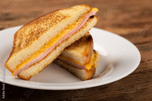 Grilled ham and cheese. Sandwich with cheese and ham on grill. photo