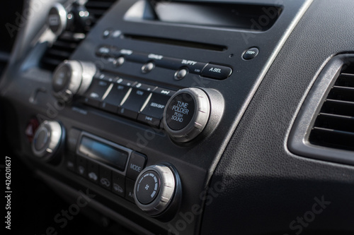 Close up of a car dashboard with a radio tuner. Selective focus.