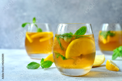 Fototapeta Naklejka Na Ścianę i Meble -  Delicious iced tea with lemon and mint in a glasses.