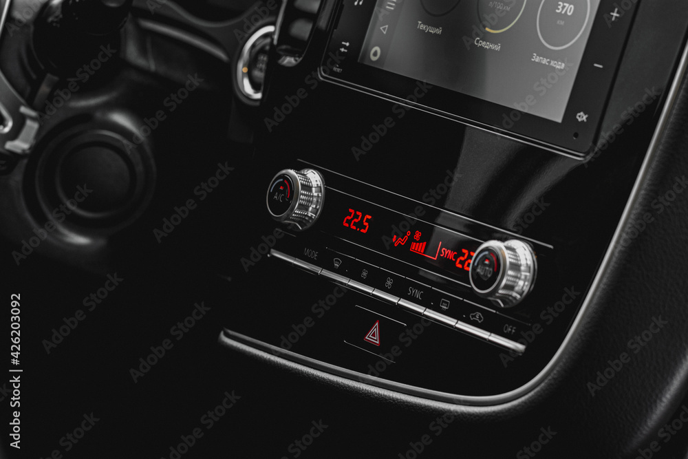Fototapeta premium Color car air conditioning buttons close up view inside a car. Car temperature conditioner dashboard panel.