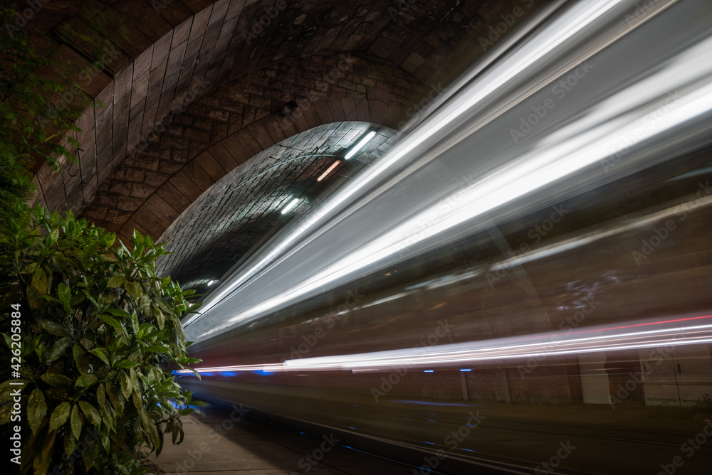 Illuminated Tramway Tunnel with Tram Light Trails at Night in Bratislava, Slovakia