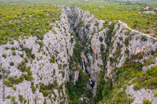 Velika Gubavica waterfall on the Cetina River in Cetina gorge, canyon. August 2020, aerial drone shot photo