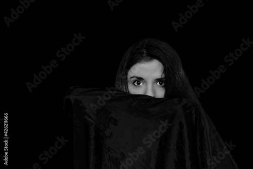 Black and white self portrait of a woman playing with a cape 