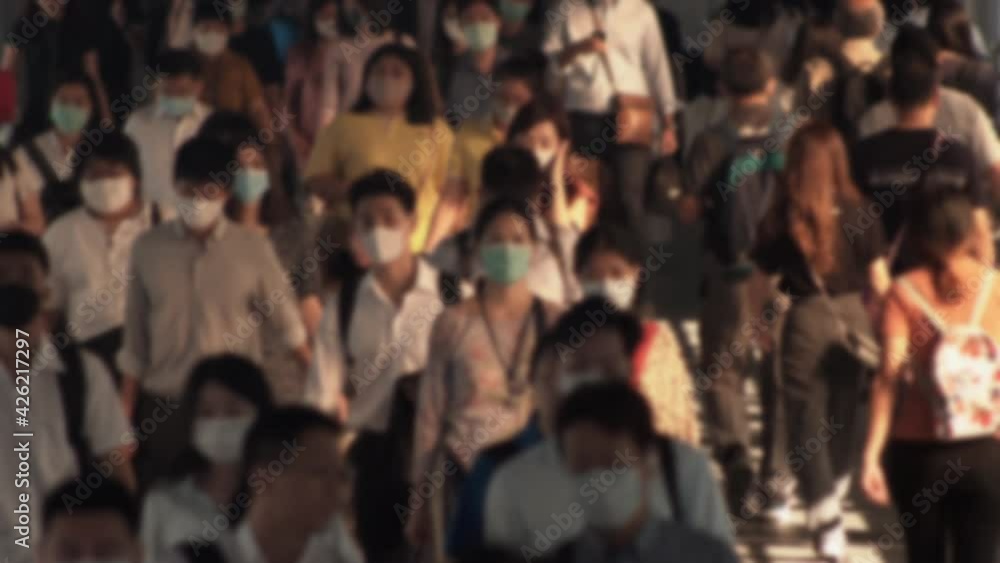4K, Blurred defocused view of Concept of coronavirus quarantine, MERS-Cov. Large crowd of business people with medical face mask. Air pollution. 4K, Blurred defocused view of Concept of coronavirus quarantine, MERS-Cov. Large crowd of business people with medical face mask. Air pollution.