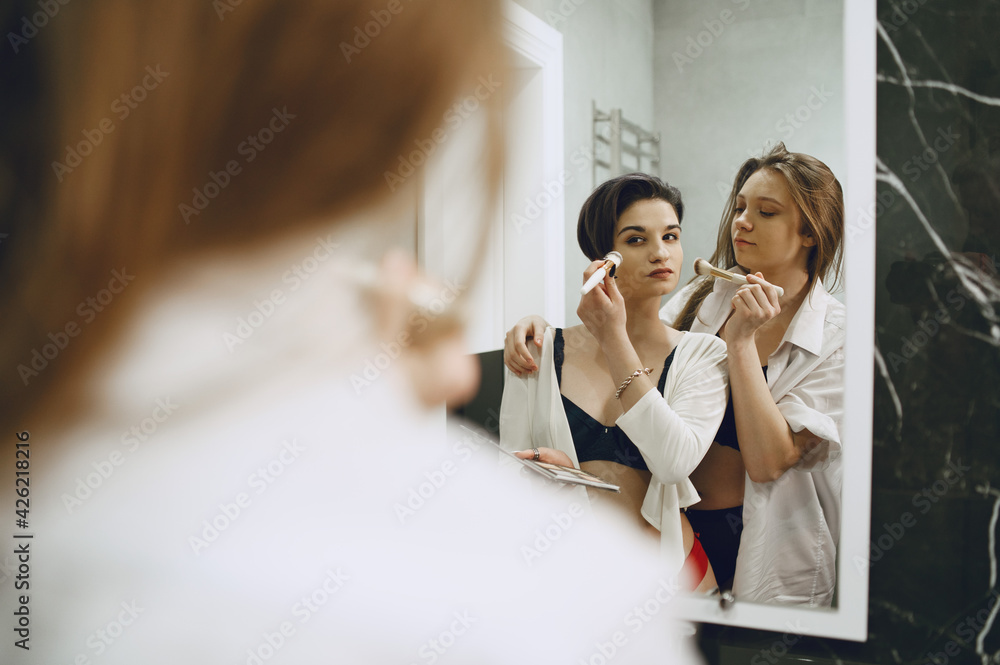 Lesbian girls doing makeup in bath