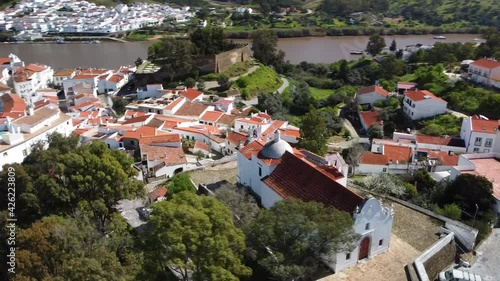 Slow motion aerial view of Alcoutim (Algarve city - Portugal). Drone movement around the beautiful Church of Nossa Senhora da Conceição photo