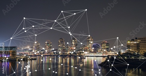 Composition of net of connections over a cityscape in background