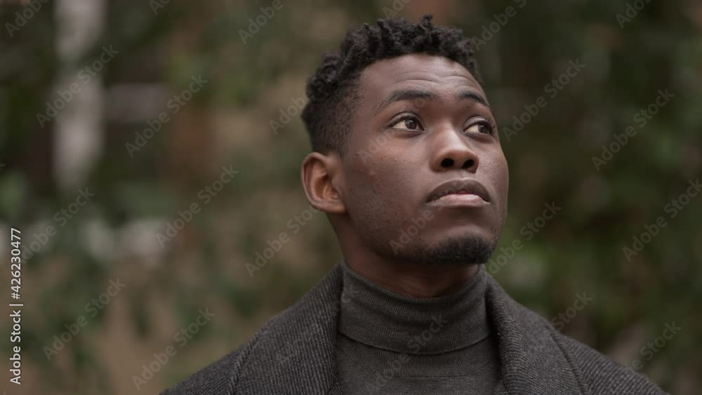 Pensive young black man standing in thought Pensive young black man standing in thought