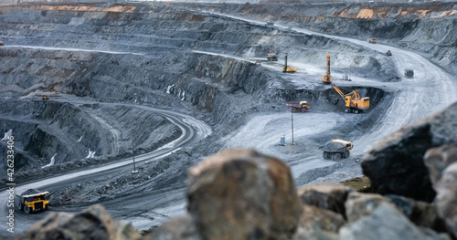 Work of heavy equipment in an open pit for gold ore mining photo