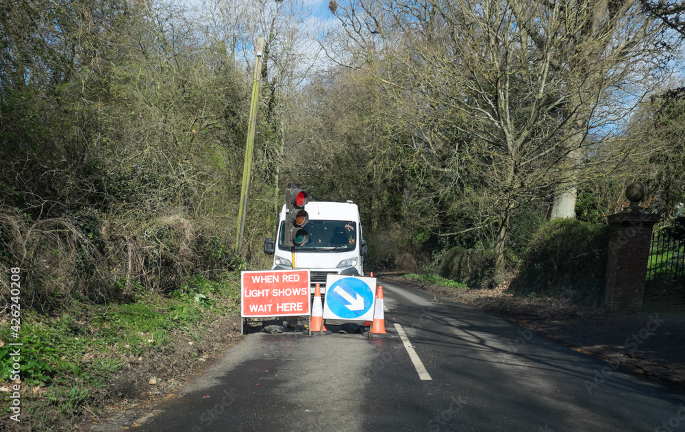 Road works with traffic light control on a country lane in Kent, England, United Kingdom