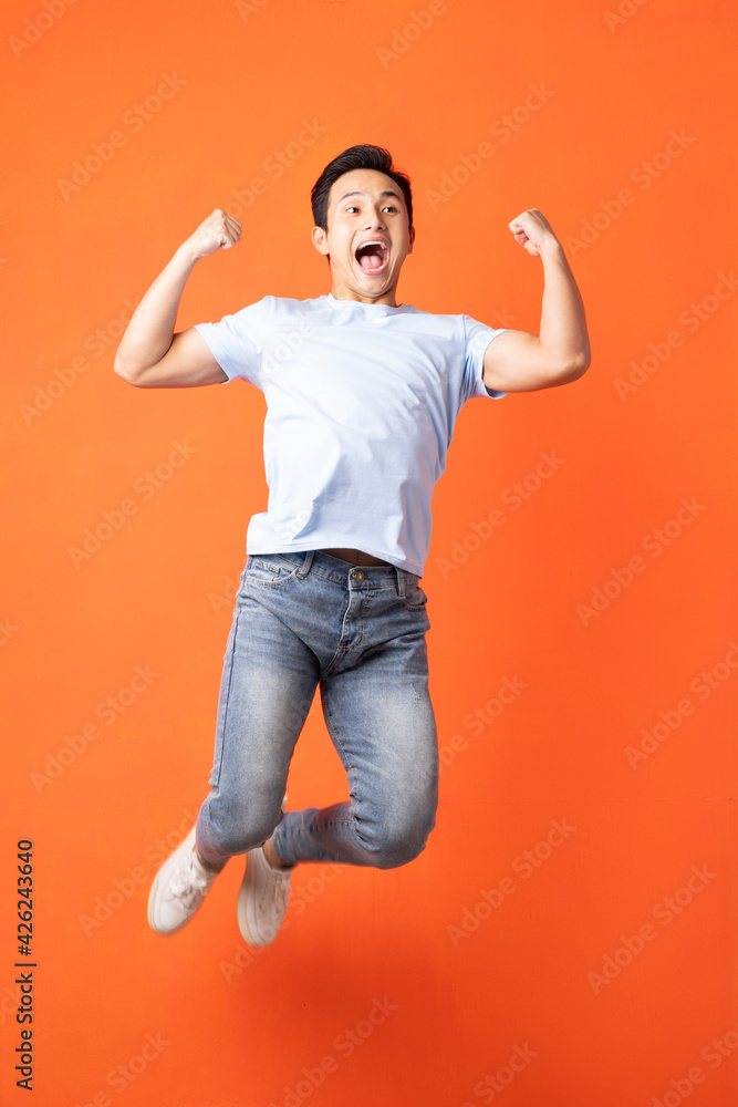 Asian man jumping and shouting