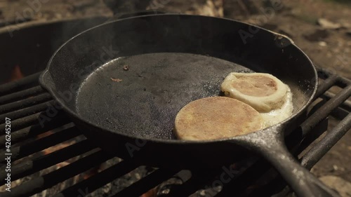 Cooker using spatula removing the fried egg from the frying pan  photo