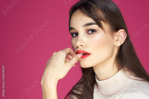 Woman with long hair and red lips white blouse pink background attractive look