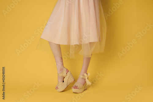 Female feet fashionable shoes attractive look yellow background lifestyle