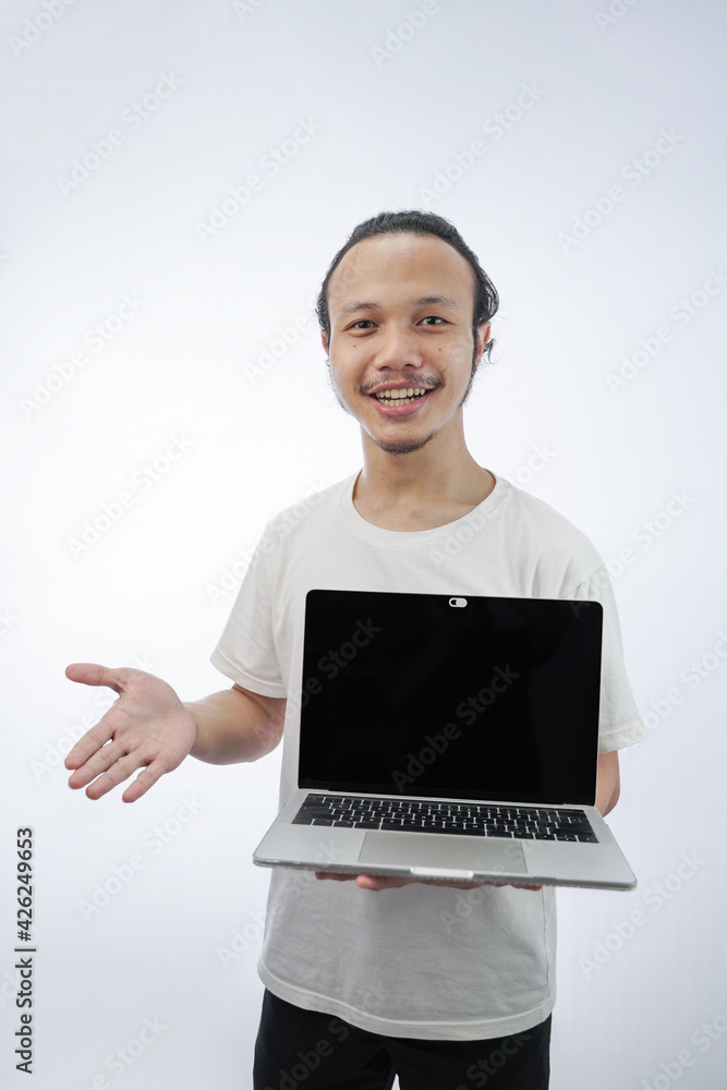 portrait of a cheerful Asian handsome man holding a laptop computer isolated in white portrait of a cheerful Asian handsome man holding a laptop computer isolated in white