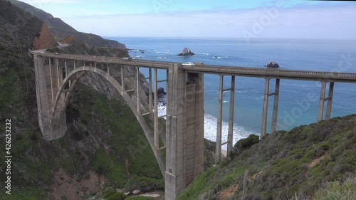 The Bixby Creek Bridge, a scenic open-spandrel arch bridge completed in 1932, is shown in Big Sur, California with the Pacific Ocean visible in the background.