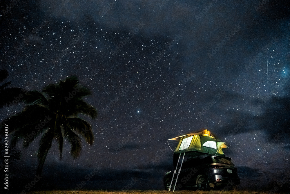 Car with roof top tent under a starry sky, overland Stock Photo