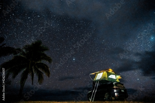 Car with roof top tent under a starry sky, overland