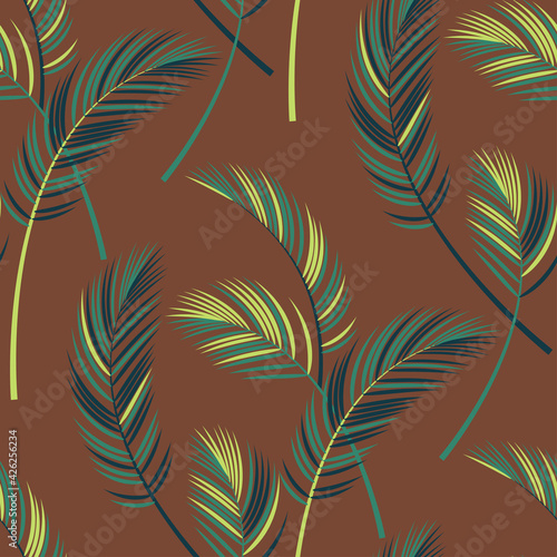 palm leaves on a brown background. seamless pattern