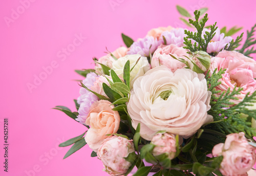 Beautiful bouquet of mixed different flowers on pink background  greeting  gift