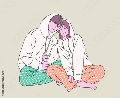 Couples Couples in pajamas are sitting affectionately. hand drawn style vector design illustrations. 
