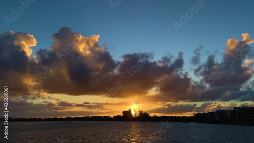 Stunning orange and teal sunset over the ocean at Pumicstone Passage, Caloundra photo