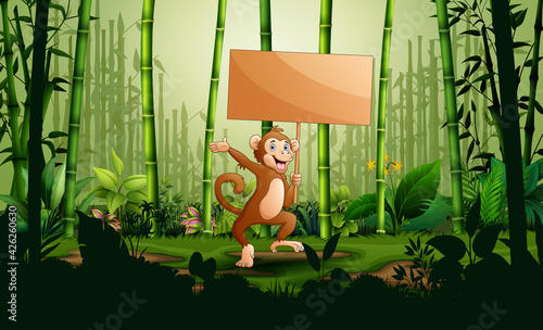 Cartoon a monkey holding wooden sign in the bamboo forest landscape