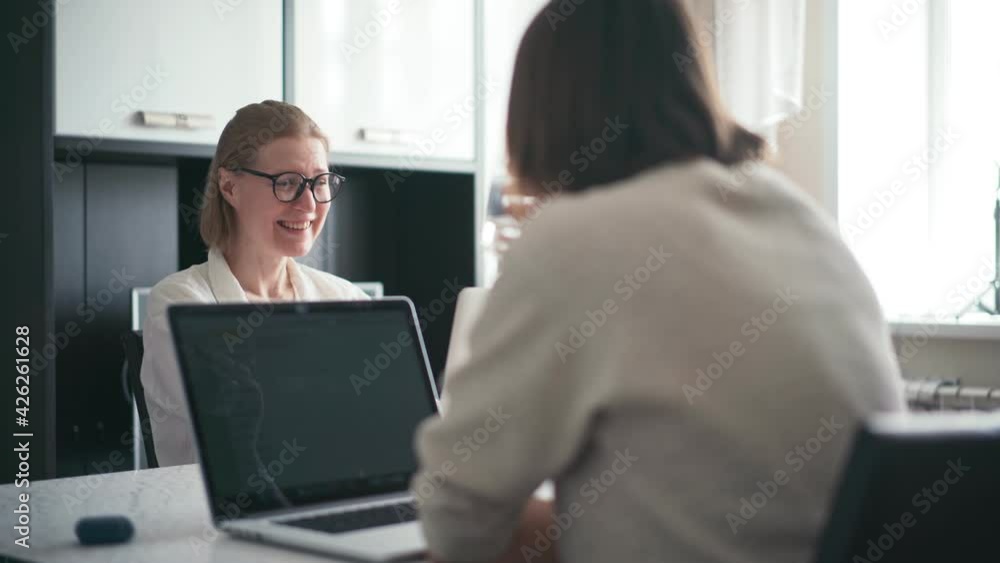 Two young women freelancers remote employee working from home on their laptops. Coworking concept. Two young women freelancers remote employee working from home on their laptops. Coworking concept.